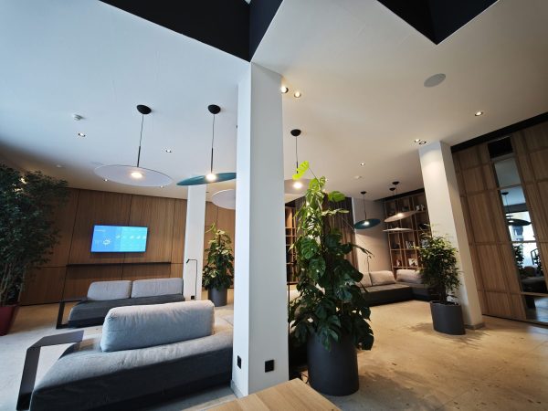 Heller Lounge-Bereich im Hotel Zeller Königsbrunn mit Deckenspots, Designleuchten und Smart Building Technik von SHI Gebäudetechnik